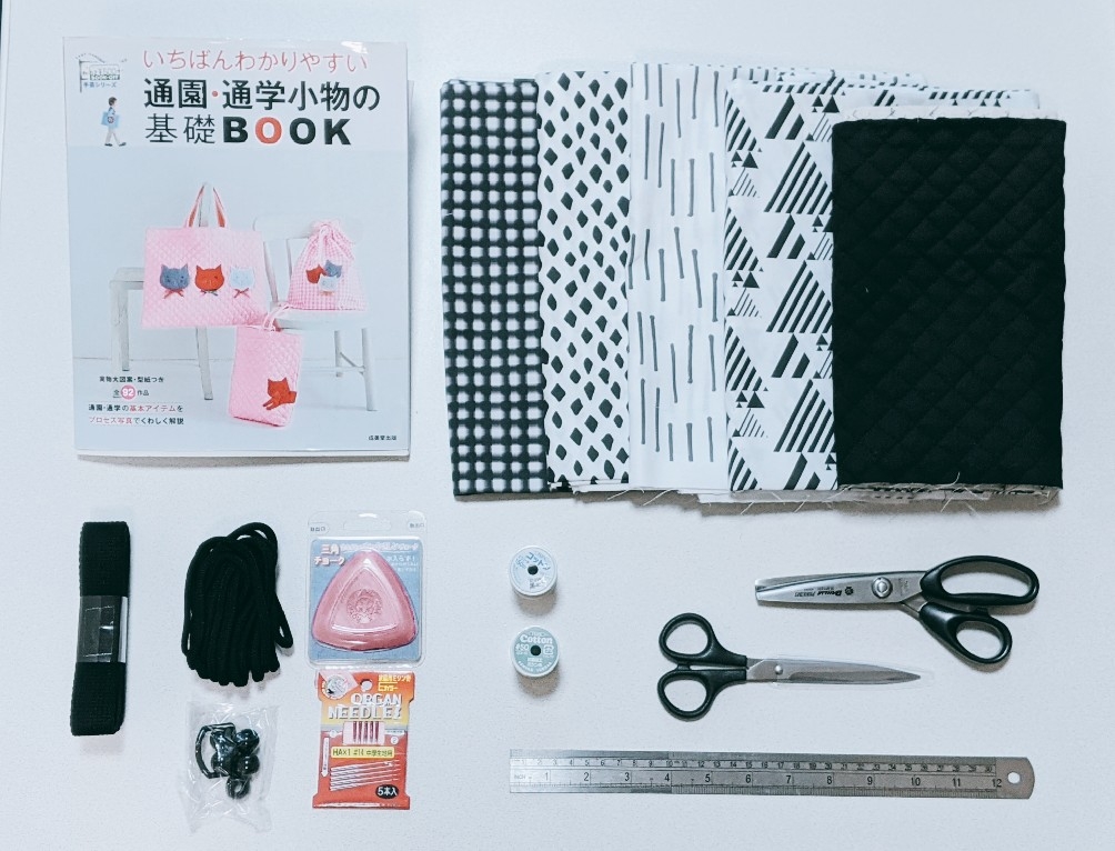 flat lay of sewing book and materials